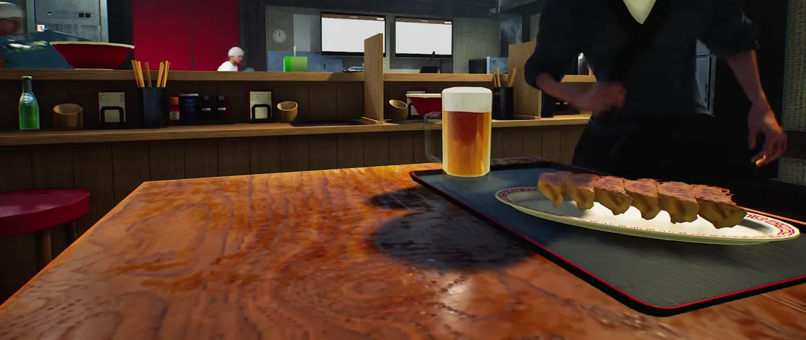 Japanese Ramen Simulator Served Beer With Thick Foam Head Japanese Ramen Simulator served draft beer with thick white foam head next to plates of gyoza on the counter