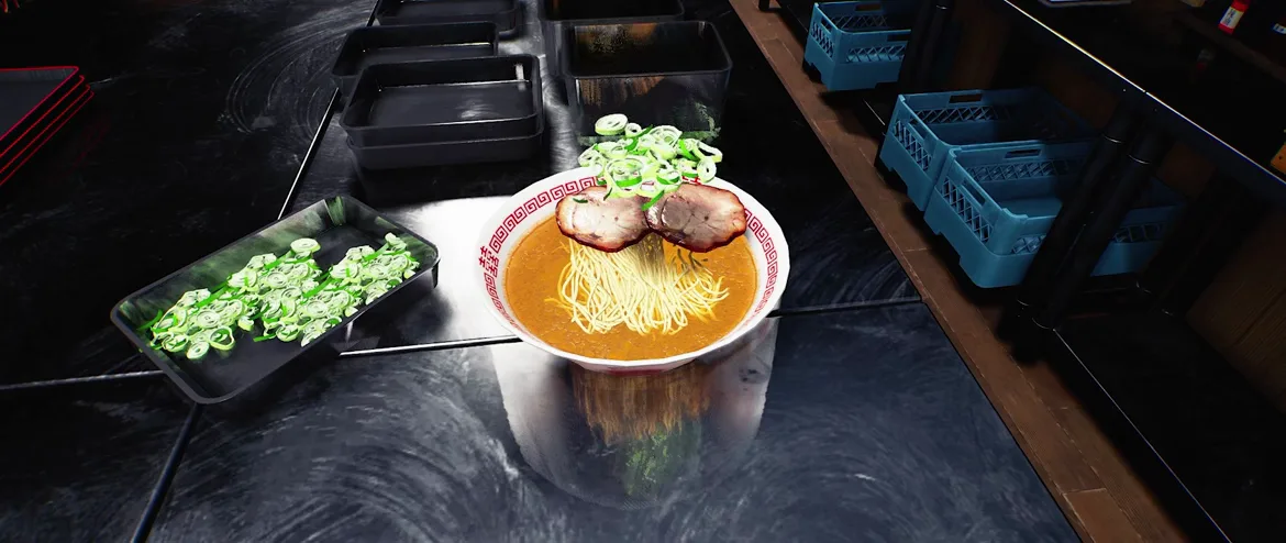 Japanese Ramen Simulator overhead view of a finished ramen bowl with orange broth, lifted noodles, two chashu slices and scallions on a black pass counter, a tray of sliced scallions at the left and blue plastic crates on the shelf at the right