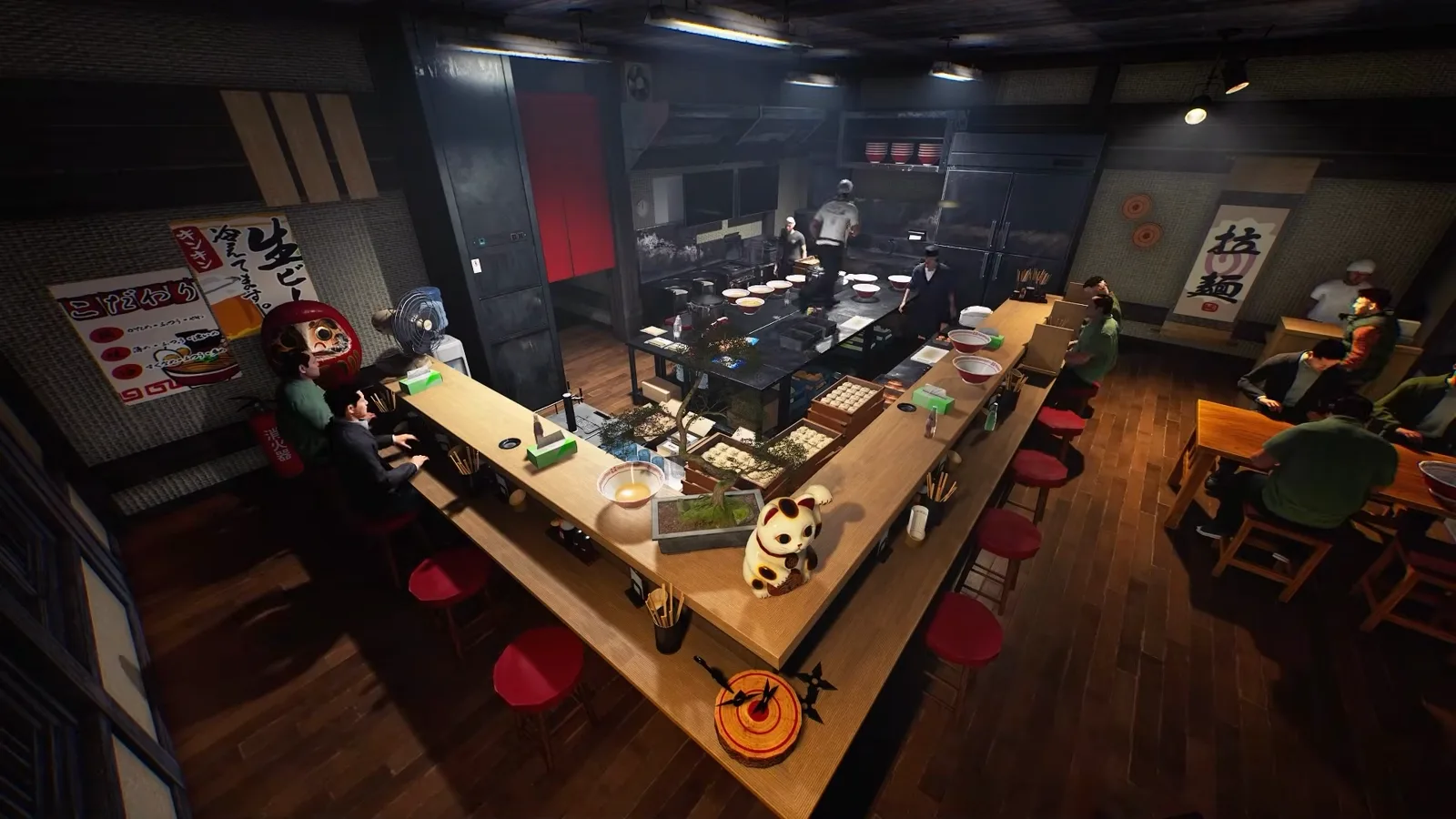 The same overhead angle of the Japanese Ramen Simulator dining room at 0:28, now with customers seated at both ends of the counter and a group standing by the right wall, while three staff keep working the open kitchen behind the pass