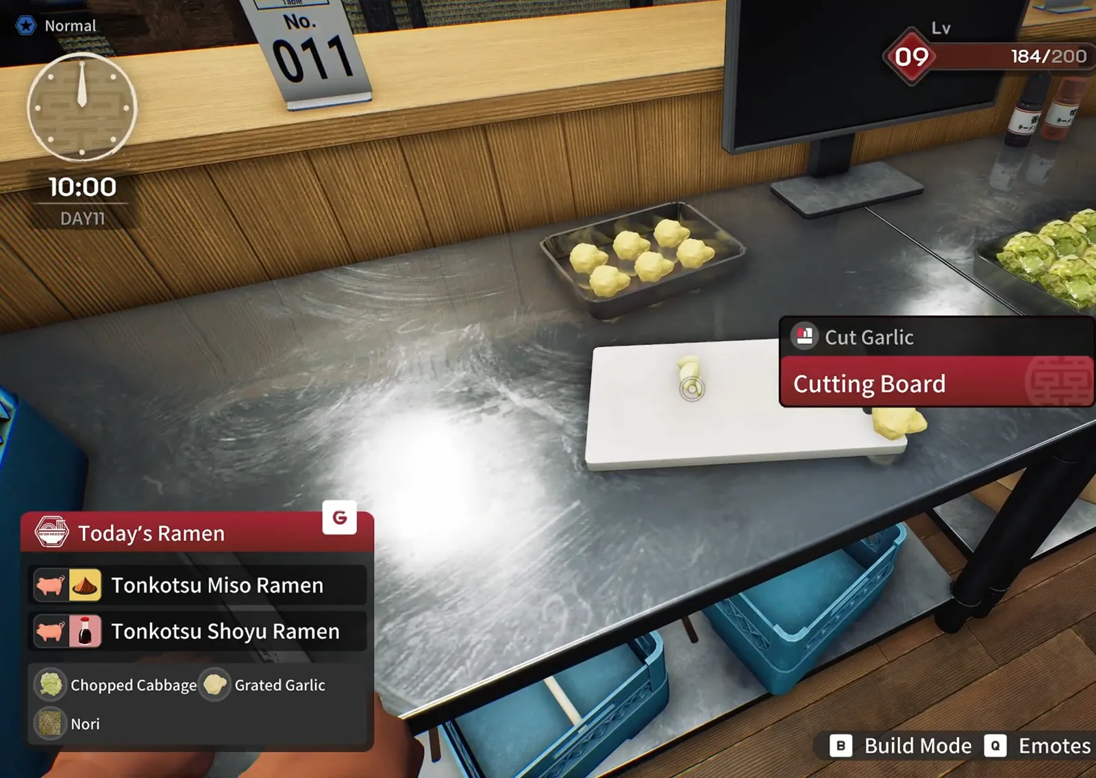 Japanese Ramen Simulator Cut Garlic prompt on a white cutting board with one garlic clove on the board and a metal tray of peeled cloves on the stainless prep counter at 10:00 on day 11 Japanese Ramen Simulator Cut Garlic prompt on a white cutting board with one garlic clove on the board and a metal tray of peeled cloves on the stainless prep counter at 10:00 on day 11