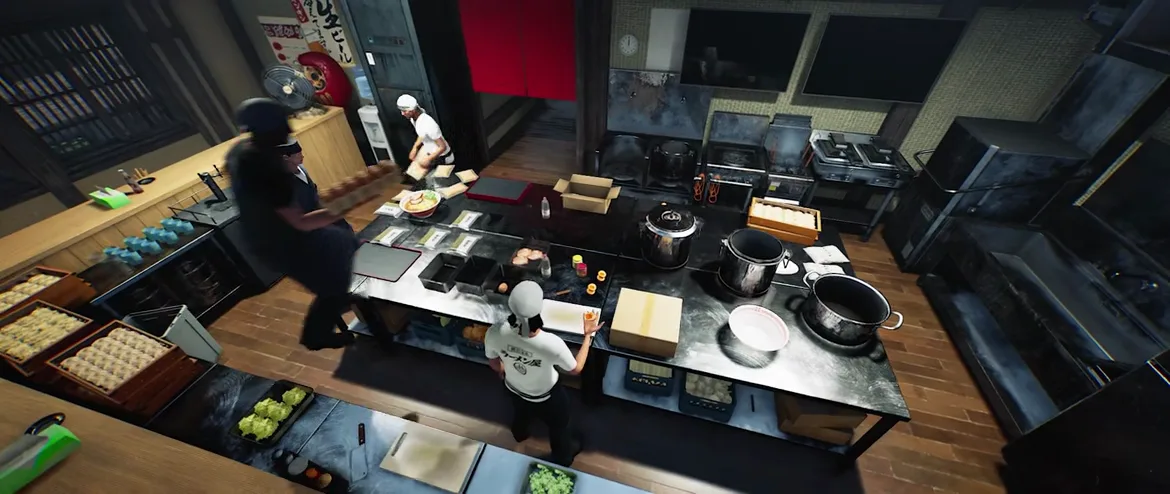 Overhead frame from Japanese Ramen Simulator showing staff moving between kitchen stations, one blurred figure crossing left and a ramen-shirt worker reaching for a condiment at the central island Overhead frame from Japanese Ramen Simulator showing staff moving between kitchen stations, one blurred figure crossing left and a ramen-shirt worker reaching for a condiment at the central island
