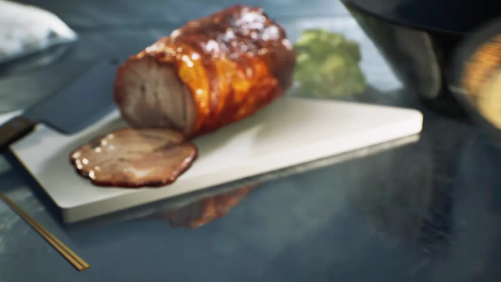 Close-up from the start of the Japanese Ramen Simulator trailer showing a slice cut from a glazed chashu roll on a white cutting board with a Japanese cleaver at the left