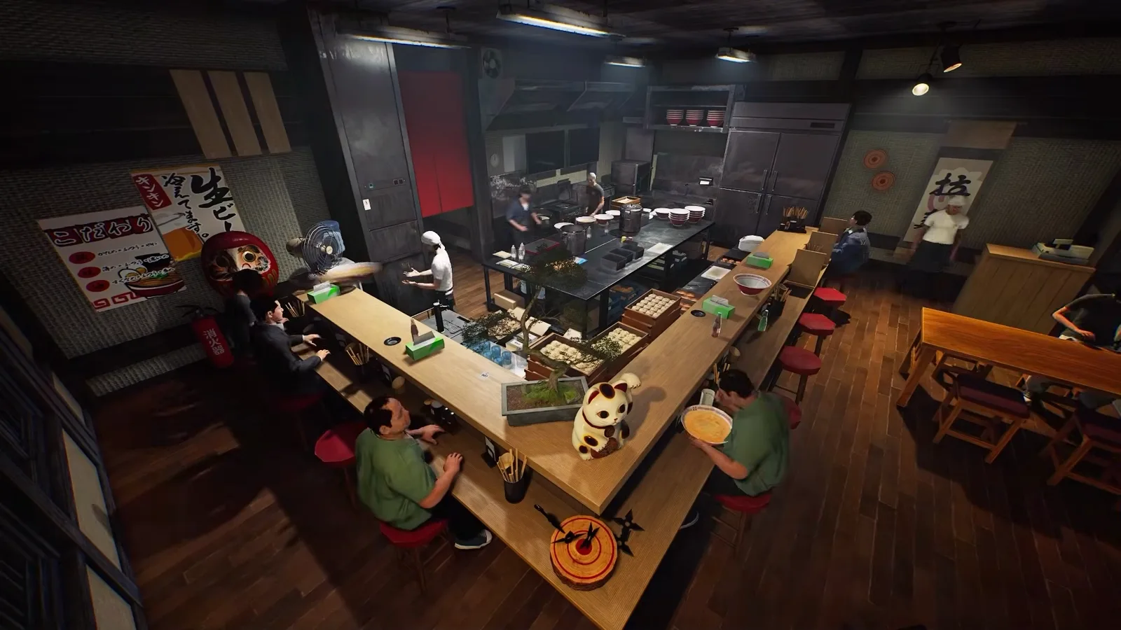 Overhead trailer shot of the Japanese Ramen Simulator dining room with customers at the L-shaped counter and tables, empty red stools along the right-hand run, cooks working the open kitchen, and a こだわり poster, red daruma, fire extinguisher and ramen scroll on the walls