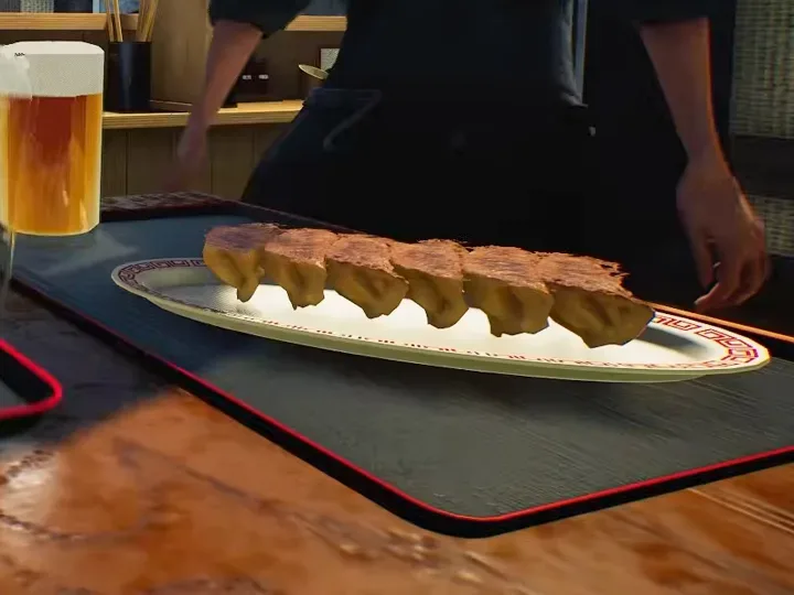 Crispy Hanetsuki Winged Gyoza: six pan-fried dumplings joined by golden crispy wings on a serving tray in Japanese Ramen Simulator